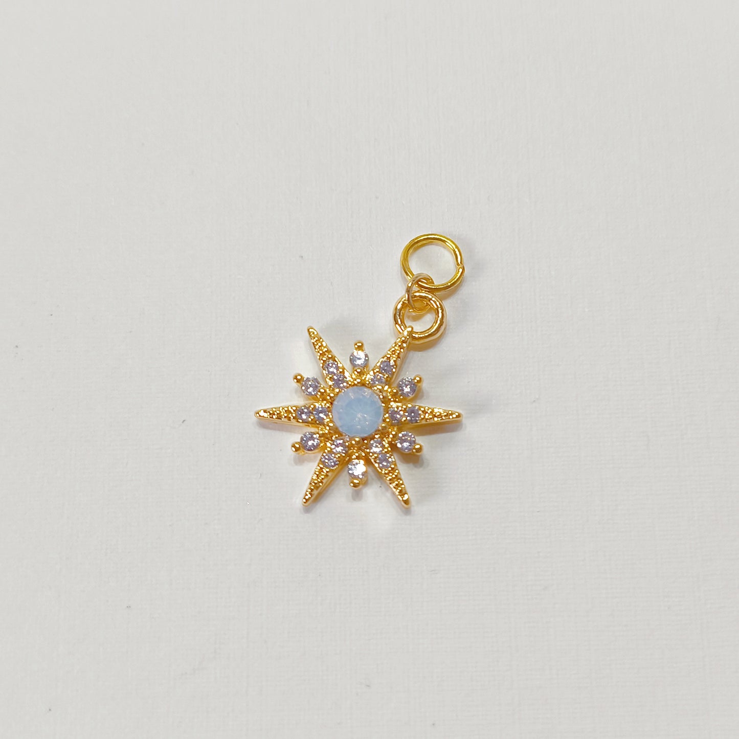 C006 gold starburst charm